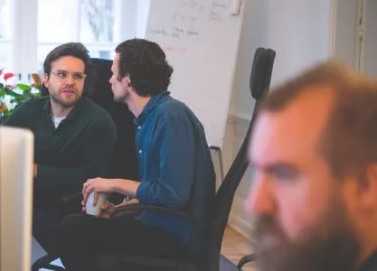 Nicolai and Mykolas from Tech Department resolving an issue